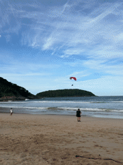 Late-night paragliding and beach activities documented in Rawai, Thailand