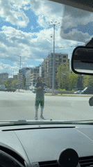 Street performer juggles tennis balls in Sofia intersection
