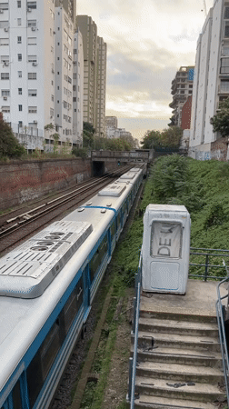 Train passes through residential cutting in Buenos Aires