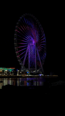 Dubai Ferris wheel displays colorful nighttime illumination