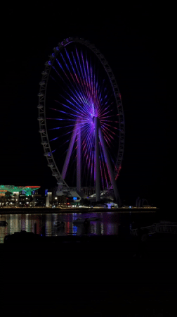 Dubai Ferris wheel displays colorful nighttime illumination