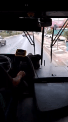 Bus driver navigates Cuiabá streets on cloudy evening