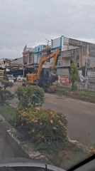 Excavator blocks street traffic in Lhokseumawe, Indonesia