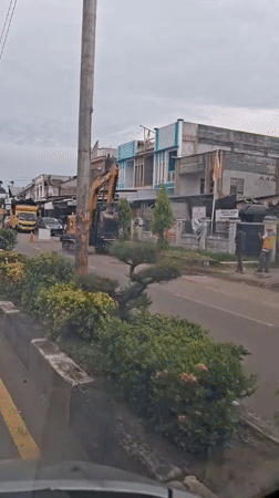 Excavator blocks street traffic in Lhokseumawe, Indonesia