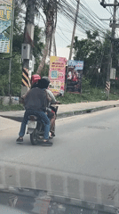 Motorcycle riders observed on overcast morning in Baan Bo Phut