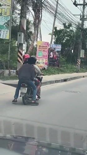 Motorcycle riders observed on overcast morning in Baan Bo Phut