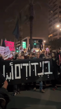 Nighttime protest in Tel Aviv draws crowds with multilingual signs