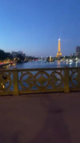 Eiffel Tower glowing at night, caught mid-stroll in Paris