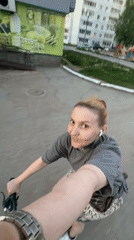 Woman cycles through Chaikovsky with earbuds, small bag