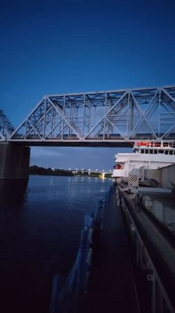 Dusk along the Shebunino riverfront, bridges and golden domes
