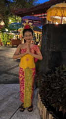 Girl in traditional Balinese dress observed in Indonesia