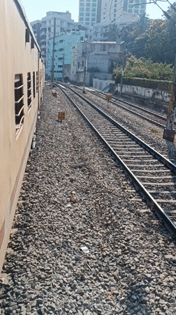 Yellow passenger train observed moving through Bengaluru before dawn