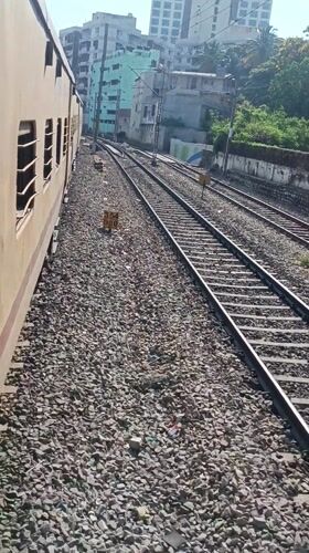 Yellow passenger train observed moving through Bengaluru before dawn