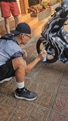 Person customizes motorcycle with zebra stripes in Nha Trang