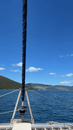 Catamaran spotted off Montenegro coast in peaceful daytime scene