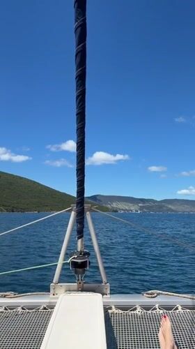 Catamaran spotted off Montenegro coast in peaceful daytime scene