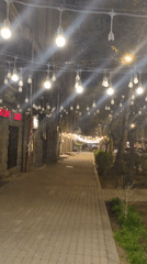 Evening stroll past shops on illuminated Yerevan street