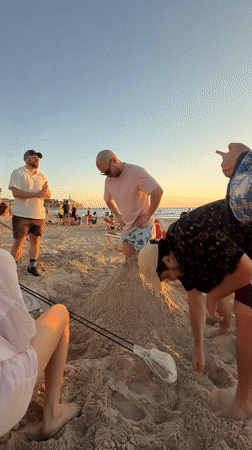 Beach sunset gathering with sand sculpting in Tel Aviv