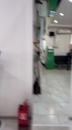 Person takes mirror selfie in Abakan office building