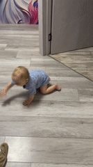 Baby in star onesie crawls while breakfast prepared