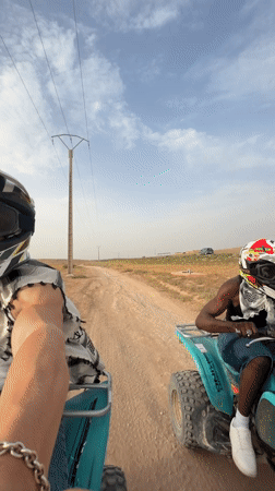 ATV riders cruise a dirt road in rural Morocco
