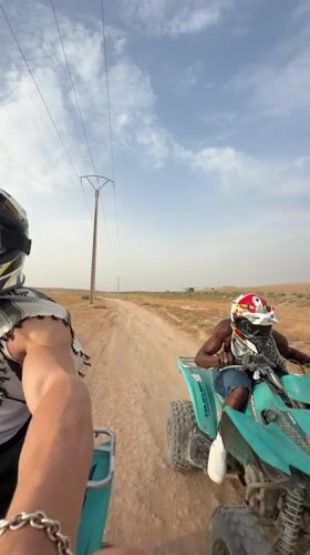 ATV riders cruise a dirt road in rural Morocco