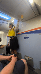 Flight attendant demonstrates safety procedures at Kastrup airport
