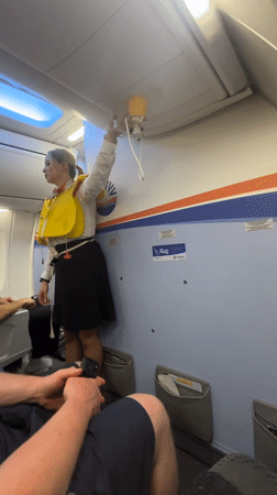 Flight attendant demonstrates safety procedures at Kastrup airport
