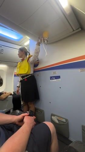 Flight attendant demonstrates safety procedures at Kastrup airport