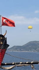 Parasailing and a flagged ship off the Alanya coast