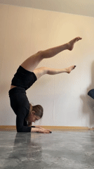 Woman performs inverted yoga pose indoors in Perm, Russia