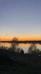 Person enjoys sunset by river in Ольховка, Russia