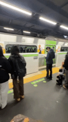 Morning commuters wait on train platform in Tokyo