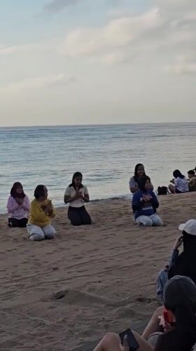 Kuta Beach at golden hour — people, vendors, and ocean views