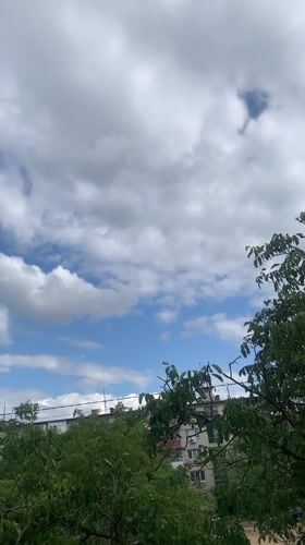 Summer skies and treetops over residential Kaniv, Ukraine