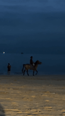 Horse rider and walker spotted on Kuta beach