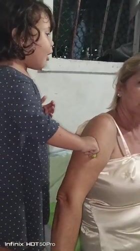 Child and woman interact indoors in Caracas