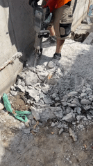 Construction worker jackhammers concrete in Plovdiv, Bulgaria