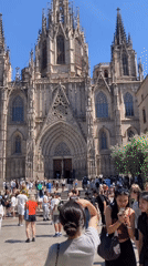 Tourist documents Barcelona Cathedral area during afternoon walkabout