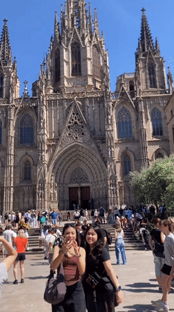 Tourist documents Barcelona Cathedral area during afternoon walkabout