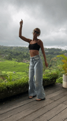 Women dance and pose on deck overlooking Penebel rice paddies