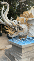 Kuta Beach scenes: ornate sea creature statue, beachside restaurant