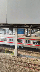 East Jakarta commuter rail and street market activity, afternoon