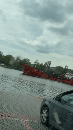 Ferry crosses waters near Beloslav, Bulgaria with vehicle passengers