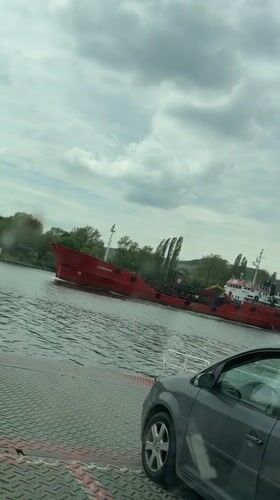 Ferry crosses waters near Beloslav, Bulgaria with vehicle passengers