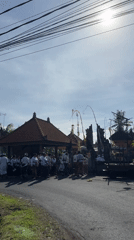Ceremonial gathering in white attire observed at Balinese temple