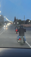 Two motorcyclists spotted on streetlit road in Pshap, Abkhazia