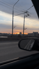 Car crosses bridge in Krasnoyarsk during sunset hours