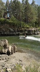 Boats navigating a green mountain river near Chemal, Russia