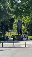 Morning park life captured around statue in Tbilisi